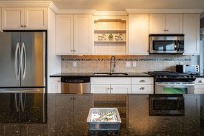 Fully equipped kitchen has plenty of space to prepare your home cooked meals