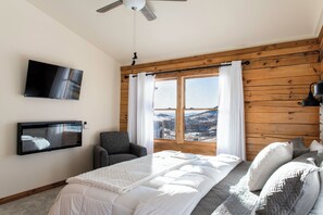 Upstairs bedroom view with smart tv and electric fireplace