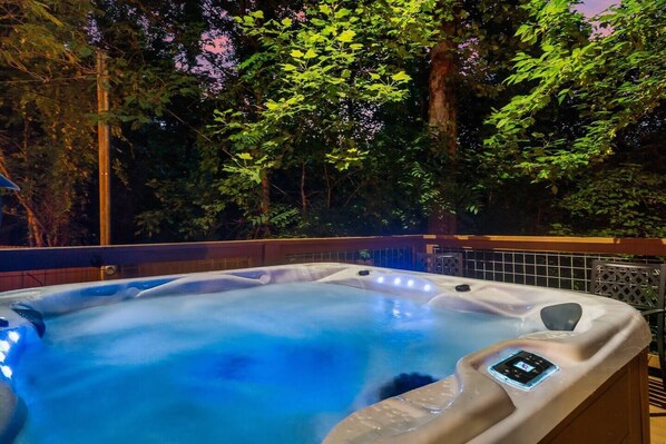 Relax in the large hot tub on the lower level deck.