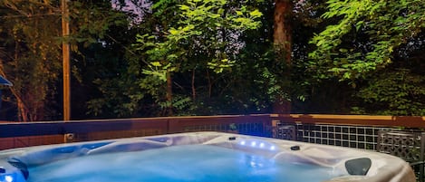 Relax in the large hot tub on the lower-level deck.