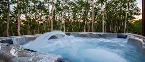 Luxurious 7 person hot tub with views of the western sunset and fire pit.