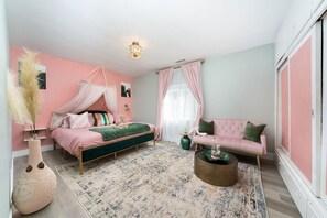 Sleep like royalty in our master suite including king-size bed and comfy pink plush sofa!