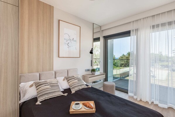 A cozy bedroom with a comfortable double bed, soft lighting, and warm wooden paneling.