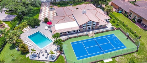 This home comes compete with Tennis court, pool, lots of space inside and out, and directly on the water.