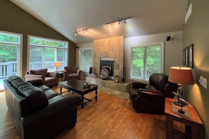 Vaulted ceiling, reclaimed hardwood floors, and lots of windows.