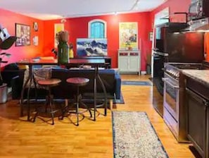 View into the kitchen with dining area, stove, fridge, sink, etc. 