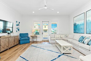 Open and airy living room with beautiful beach theme.