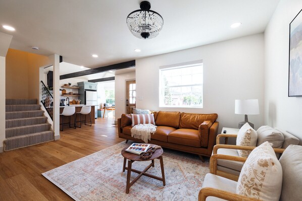 Living room: cozy seating, TV, coffee table books.
