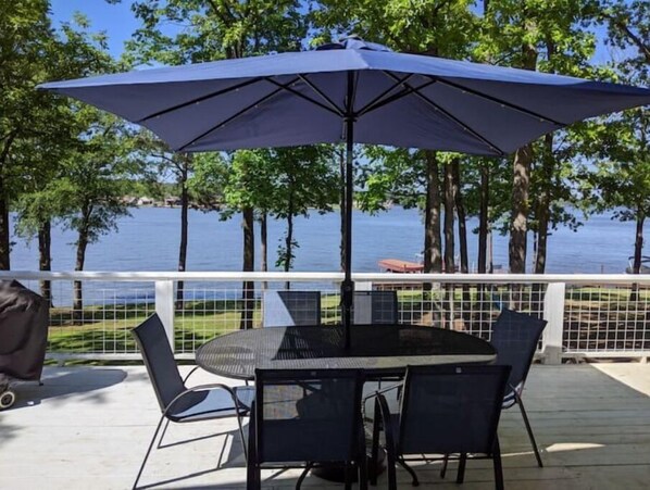 Alfesco dining awaits on this spacious deck with breathtaking lakefront views.