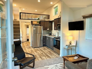 Kick back in the comfortable living room & kitchen with full-size appliances.