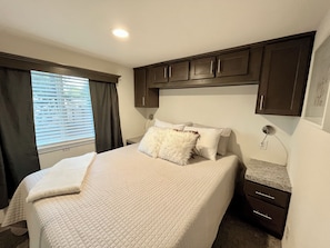 Cozy up in the private bedroom with snug queen bed. Enjoy the closet & storage!