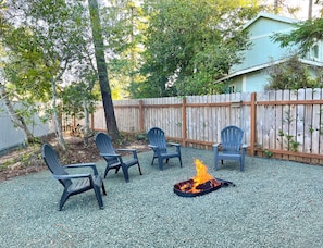 Relax around the firepit, private and tucked in behind the tiny home. 
