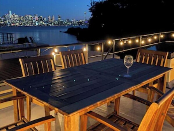 Large roof top deck with two seating areas. 