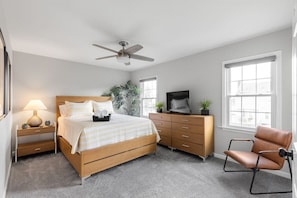 Secondary bedroom with queen-sized bed, ample dresser space, ceiling fan and flat screen Roku TV.