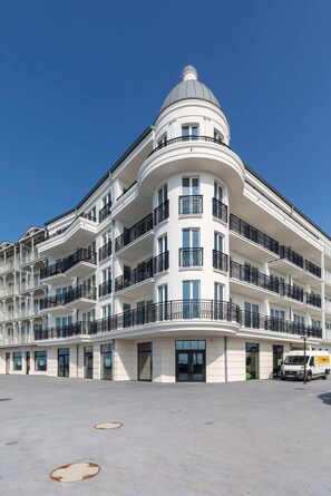A striking building with a triangular rooftop, captured from the street level.