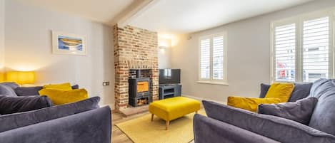 Queenie's Cottage, Wells-next-the-Sea: A colourful sitting room with plenty of natural light