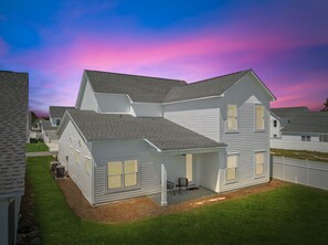 Backside entrance with paved backyard paotio