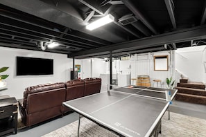 The ping pong table is the perfect way to challenge your friends or family to a game, and the couch is the perfect place to relax and watch the game. 