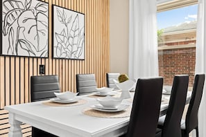 The white dishes and black chairs give this dining room a clean and modern look.