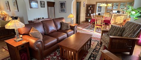 Original arches and crown molding are accentuated with period mission furniture.