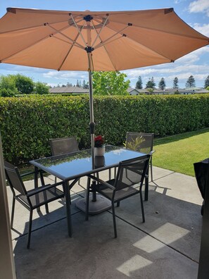 Sunny outdoor living with the trees of Marine Parade in the distance.