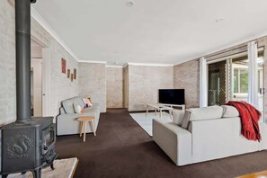 Downstairs lounge with smart TV and wood fire