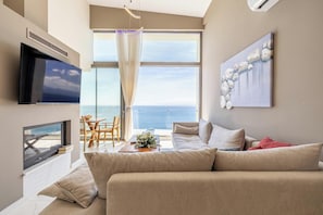 Step into the elegant living area, featuring a cozy corner sofa, a 55 smart TV, and a fireplace!