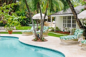 Our heated pool, equipped with pool loungers, umbrellas, pool floats, lounge seating, dining table, outdoor bar, and a sonos sound system.