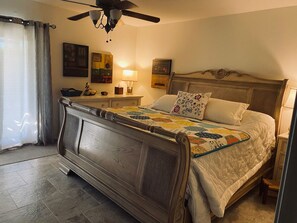 Master bedroom with french doors to private outdoor space with fire pit.