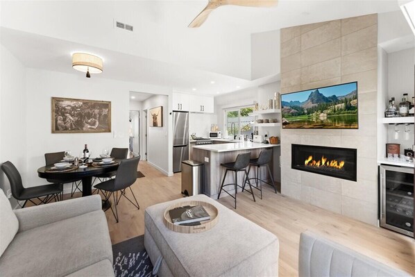 Open plan living, dining room and kitchen. with gas fireplace and wet bar.