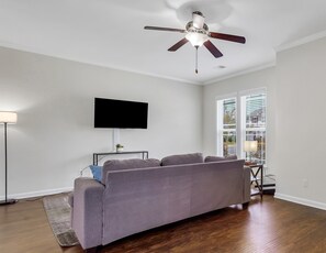 Spacious living room with 50" Roku TV and games