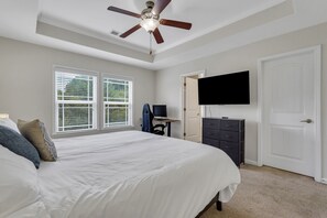 Beautiful bedroom with king bed, memory foam mattress, standing desk, and 50" Roku TV. Ensuite bathroom and walk-in closet