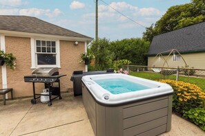 Relax in the Hot Tub surrounded by plush landscaping