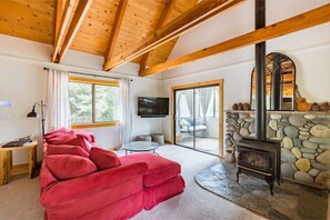 Main living area with a view to the sunroom and the fireplace.