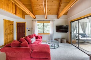 The red door leads to the side yard, patio and picnic table.