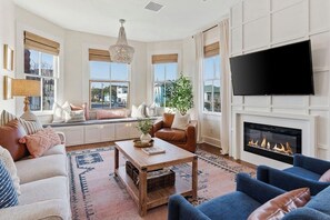 Cozy living room with fireplace, La-z-Boy sofa, and window bench