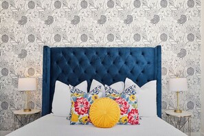 2nd bedroom with king bed and a beautiful wallpaper feature wall