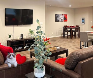Relax at the best Airbnb in Lake Charles! Enjoy a spacious living area with comfortable Ashley fabric furniture and a 65" 4K TCL ROKU Smart TV for your favorite shows.