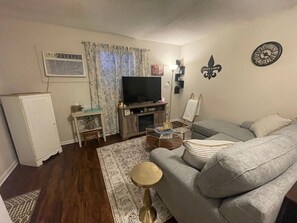A cozy living room complete with comfortable couches and tasteful rustic decorations.