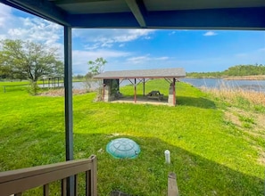 A beautiful wooden deck attached to the cabin, offering a perfect spot to relax and enjoy the tranquil bayou views.