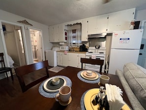 A quaint dining area that provides a lovely view of the bayou, perfect for enjoying meals with a natural backdrop.