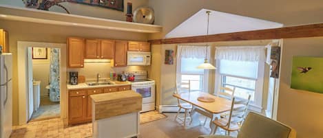 Main living area, with a full size fridge and electric stove.