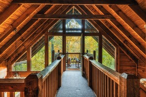 The cabin's walkway to upper deck with vaulted wood ceilings and lots of natural light. Photo taken in the autumn.