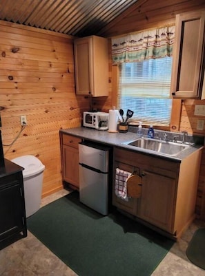 Mini Kitchen, with dorm frig, sink, coffee pot and service for 4. 