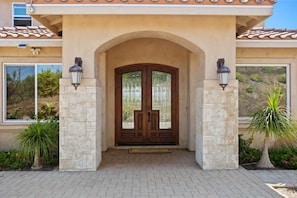 Enter the large double-door entryway with smart, keyless lock. 