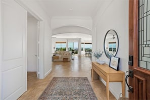 A spacious entry with arched hallways and your first peek at the scenic views.