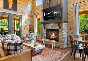 Snuggle up by the fire after a day of adventure. This living room is your cozy retreat in the woods!