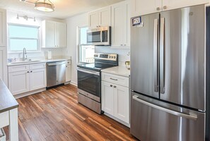 Fully stocked kitchen includes pots, pans, Keurig, dinnerware, glassware, etc.