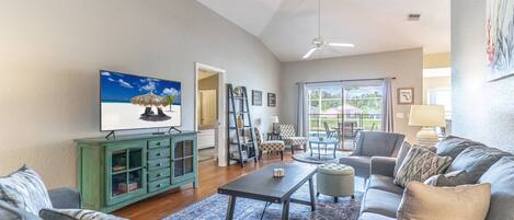 Bright and spacious living room with access to the private pool