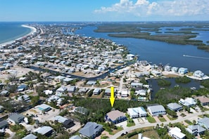 Located south of mid-island, the duplex sits on the edge of the mangrove bordering a peaceful canal that leads to the Estero Bay.